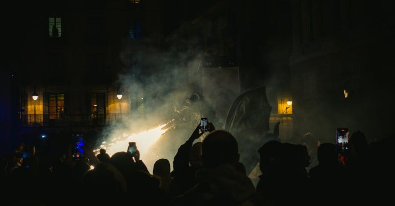 Performance Gap - A crowd of people standing in front of a building with smoke coming out of it