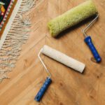 Tools - Paint Rollers Lying on a Wooden Floor 