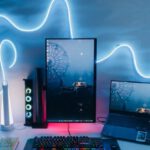 Desk Setup - Modern Desk Setup with a Vertical Monitor, Laptop and a Neon Light on the Wall