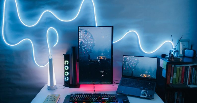 Desk Setup - Modern Desk Setup with a Vertical Monitor, Laptop and a Neon Light on the Wall